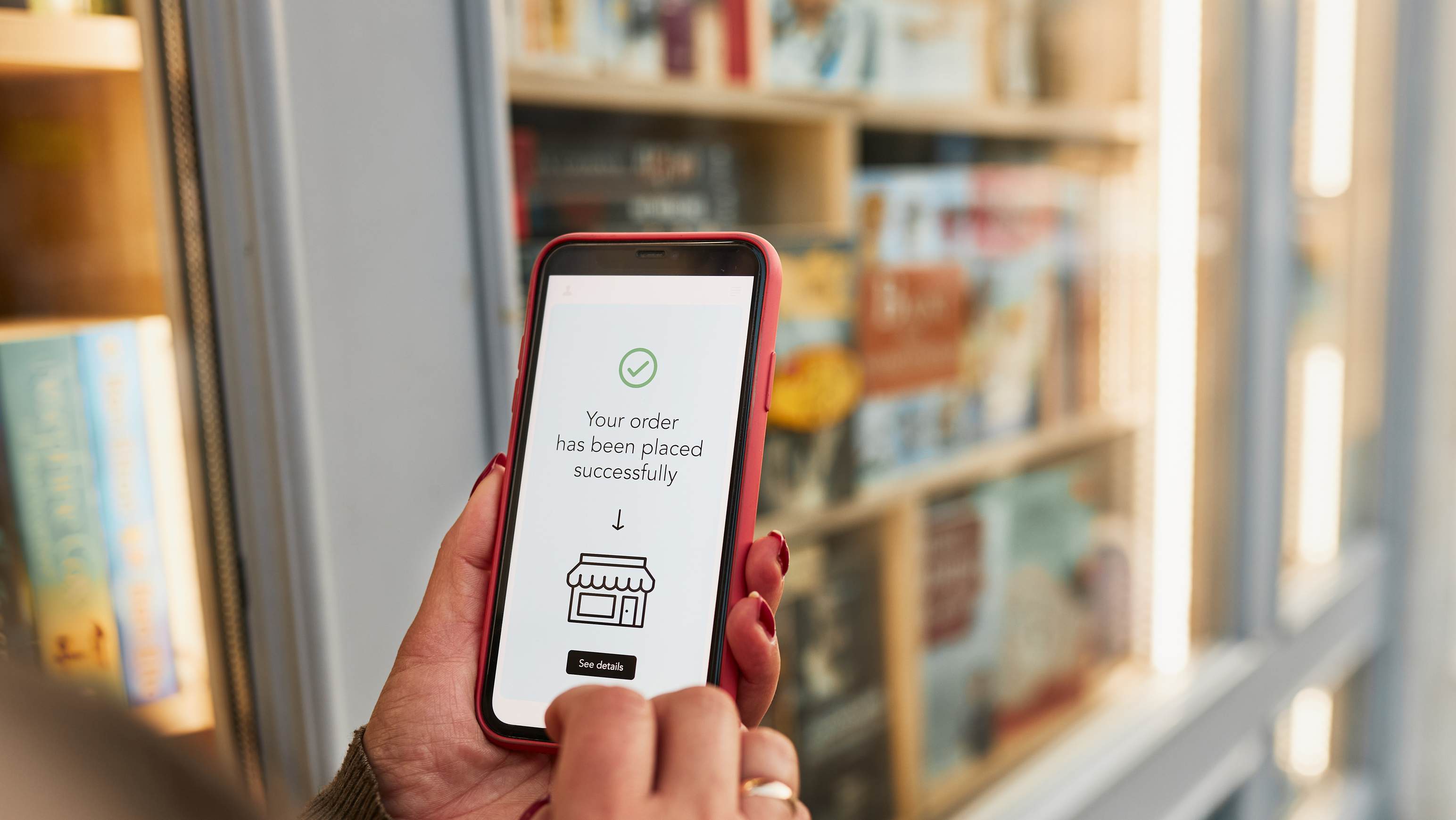 A customer using a phone to view an order confirmation